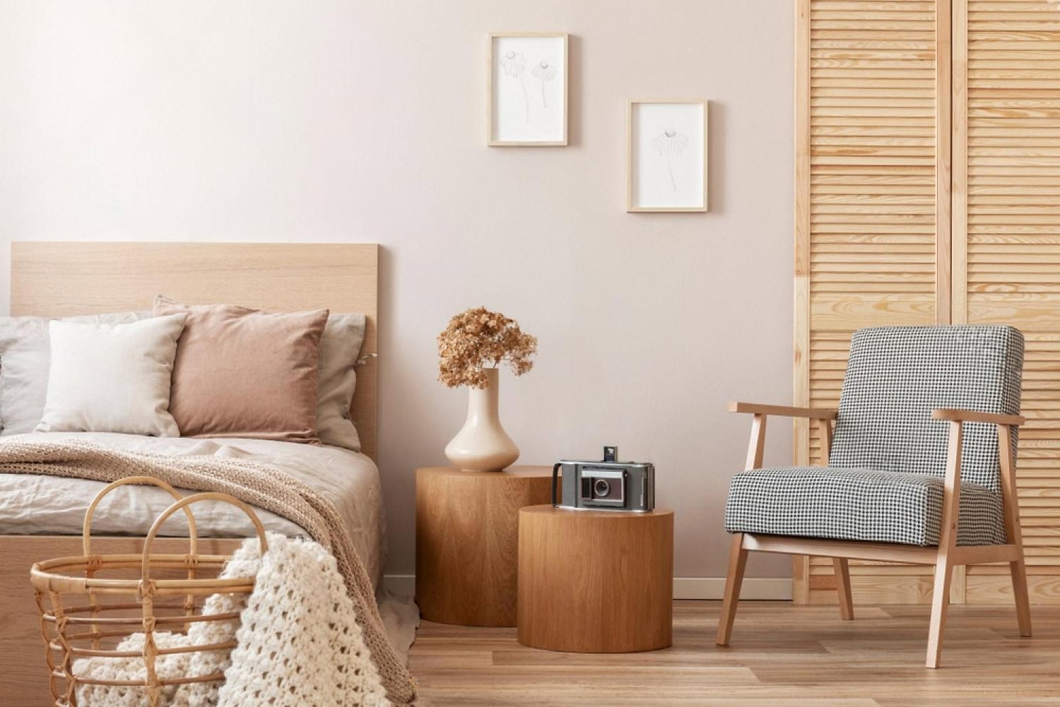 Bedroom set with wooden bed frame, side tables and armchair for a Dubai rental apartment
