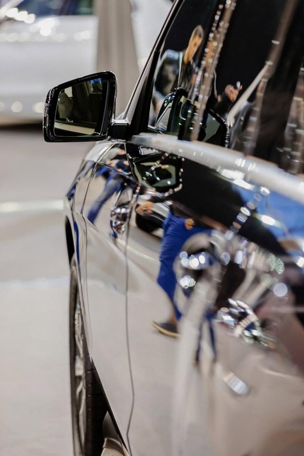 Reflection on the polished flank of a luxury car at a Dubai showroom