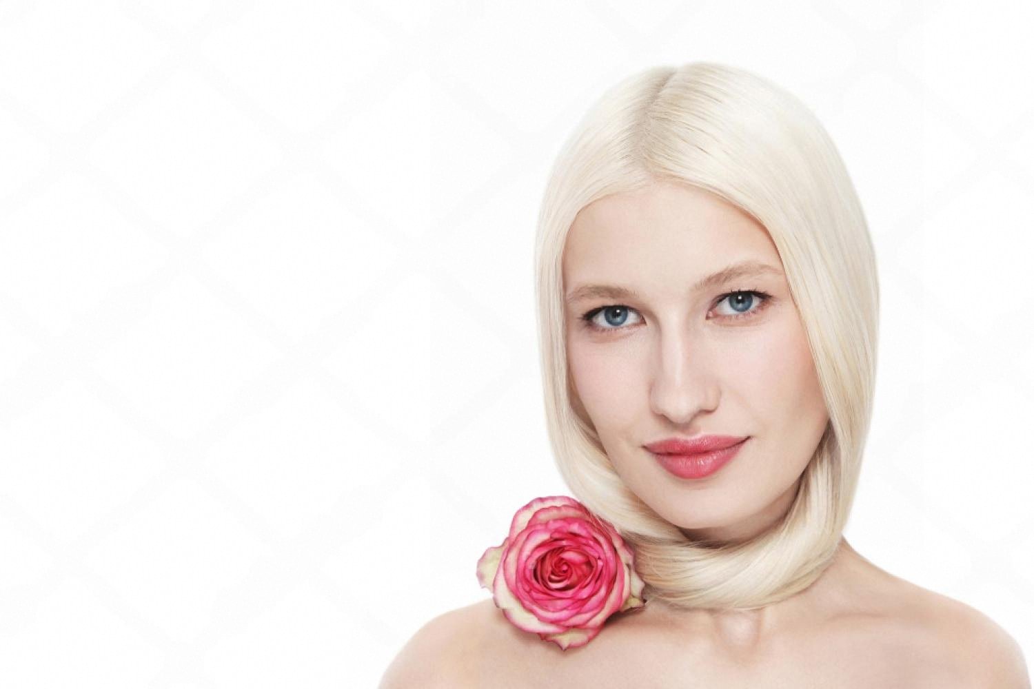 Woman with soft pink lip blushing results holding a rose